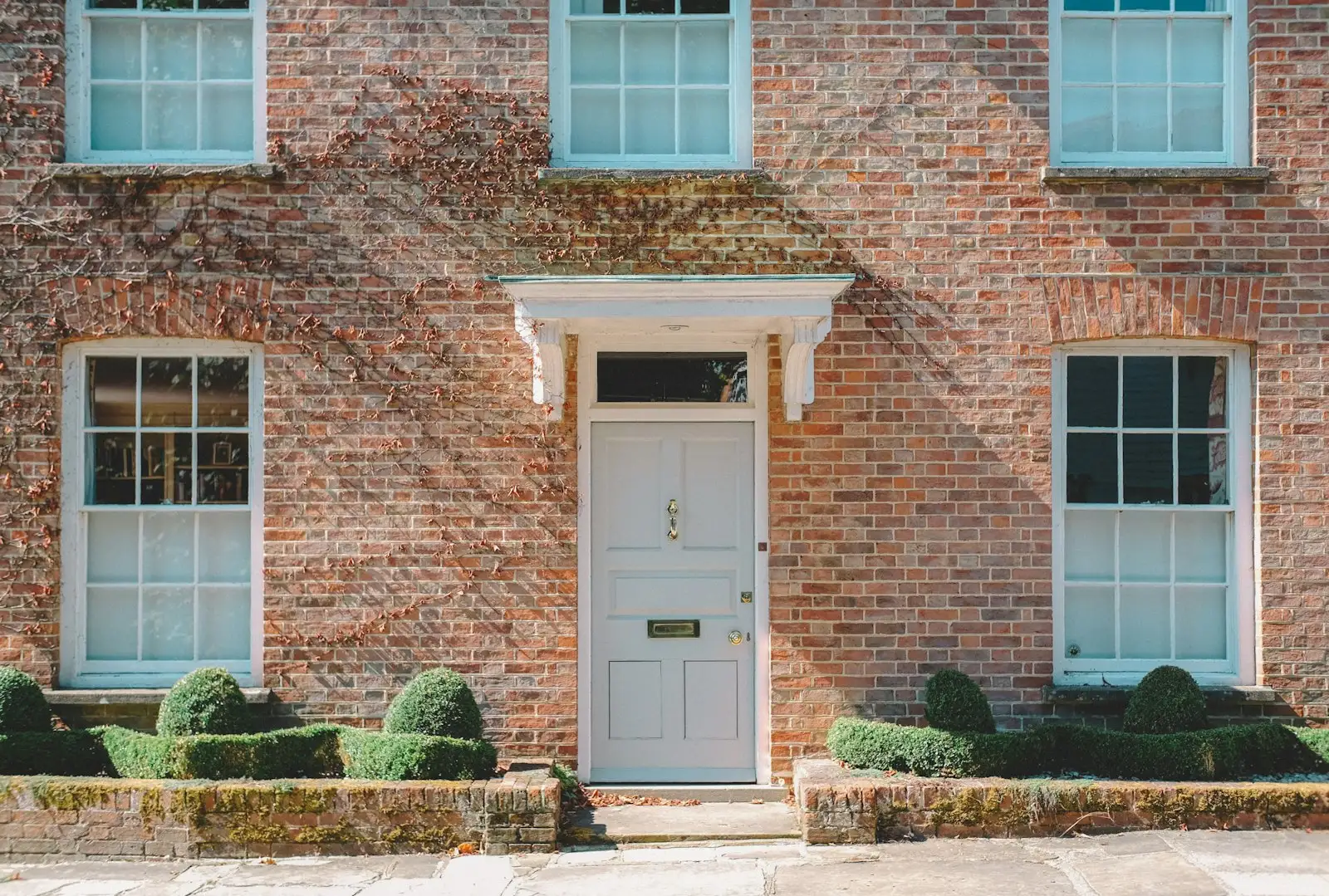 A period brick townhouse with a panelled front door